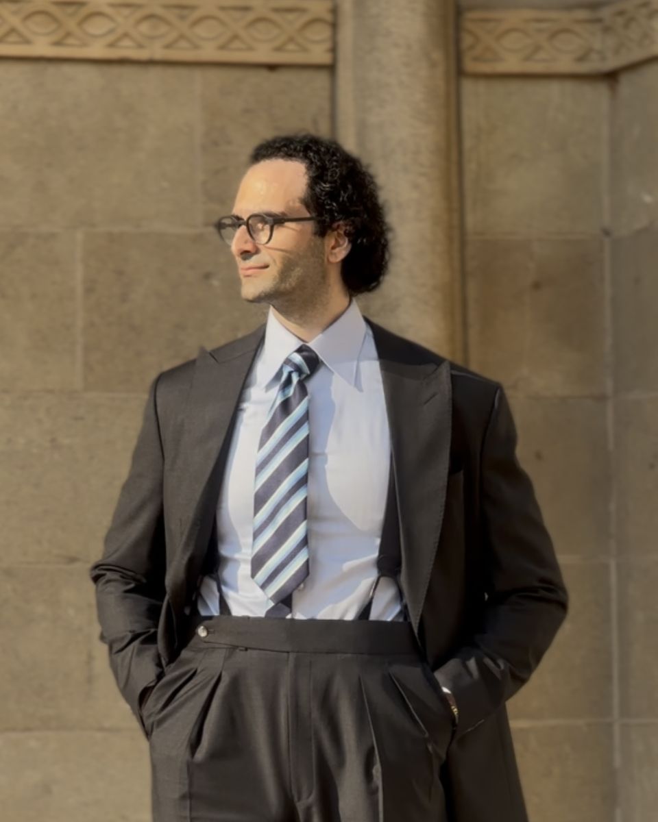 Kamal Raydan, in a suit and tie, looking out of frame